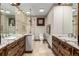 A spacious bathroom featuring double vanities, granite countertops, tile floors, and a glass enclosed shower at 6740 S Windermere St, Littleton, CO 80120