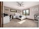 A serene bedroom with large windows, a ceiling fan, and a neutral color palette that fills the space at 6740 S Windermere St, Littleton, CO 80120