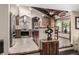 Modern kitchen with stainless steel appliances, custom cabinets, and a breakfast bar with tile floors at 6740 S Windermere St, Littleton, CO 80120