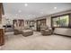 Open-concept living room featuring plush seating, neutral color palette and lots of natural light at 6740 S Windermere St, Littleton, CO 80120
