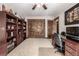 Spacious home office with custom cabinetry, a comfortable executive chair, and natural light from nearby windows at 6740 S Windermere St, Littleton, CO 80120