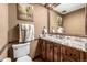 Stylish powder room with custom vanity, granite countertop, and decorative mirror at 6740 S Windermere St, Littleton, CO 80120