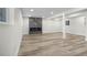 Spacious basement featuring a modern fireplace, light-colored wood floors, and recessed lighting throughout at 11877 Keough Dr, Northglenn, CO 80233
