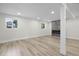 Spacious basement featuring modern fireplace, recessed lighting, large windows, and contemporary flooring throughout at 11877 Keough Dr, Northglenn, CO 80233