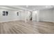 Large finished basement featuring wood floors, several windows, and an open layout, perfect for entertaining at 11877 Keough Dr, Northglenn, CO 80233