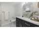 Elegant bathroom featuring a vanity with gold accents, a large mirror, and a beautifully tiled walk-in shower at 11877 Keough Dr, Northglenn, CO 80233