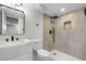 Modern bathroom featuring a stylish vanity, toilet, and a luxurious shower with sleek black fixtures, and decorative tile accent at 11877 Keough Dr, Northglenn, CO 80233