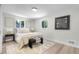 Bright bedroom with neutral decor, featuring a comfortable bed, modern artwork, and natural light from the windows at 11877 Keough Dr, Northglenn, CO 80233