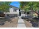Charming two-story home featuring a well-manicured lawn, a gray door, and a concrete pathway leading to the entrance at 11877 Keough Dr, Northglenn, CO 80233