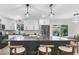 Modern kitchen with white cabinets, stainless steel appliances, a black island and stylish pendant lighting at 11877 Keough Dr, Northglenn, CO 80233