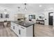 Bright and open living area features a kitchen, dining space, and a comfortable seating area with fireplace at 11877 Keough Dr, Northglenn, CO 80233