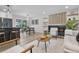 Open-concept living space with a modern kitchen, dining area, fireplace, and comfortable seating arrangement at 11877 Keough Dr, Northglenn, CO 80233