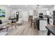 Open-concept design with a kitchen island, casual seating, and a living area showcasing modern decor and natural light at 11877 Keough Dr, Northglenn, CO 80233