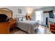 Comfortable bedroom featuring a large window, wood floors, and vintage furniture at 19807 Victorian Way, Parker, CO 80138