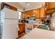 Functional kitchen featuring wood cabinets, efficient appliances, and clean white counters at 19807 Victorian Way, Parker, CO 80138
