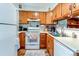 Bright kitchen with white appliances, wood cabinets and ample counter space at 19807 Victorian Way, Parker, CO 80138