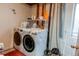 Laundry room with a white washer and dryer next to a window at 19807 Victorian Way, Parker, CO 80138