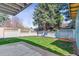 Backyard featuring a well-maintained lawn, trees and a concrete patio area at 3722 S Quebec St, Denver, CO 80237