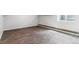 Finished basement area with modern vinyl flooring and a window for natural light at 3722 S Quebec St, Denver, CO 80237