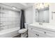 Bright bathroom features a modern vanity, tiled shower, and updated fixtures at 3722 S Quebec St, Denver, CO 80237
