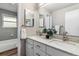 Bathroom featuring double sinks, vanity, and a shower-tub combination with tile surround at 3722 S Quebec St, Denver, CO 80237