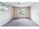Bedroom features light walls, gray carpet, and two windows, offering plenty of natural light at 3722 S Quebec St, Denver, CO 80237
