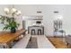 Modern dining room with stylish light fixture, hardwood flooring, and view of the kitchen at 3722 S Quebec St, Denver, CO 80237