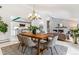 Bright dining room with stylish dining table, hardwood flooring, and view of the living room at 3722 S Quebec St, Denver, CO 80237