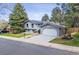 Charming two-story home with blue paint, well-manicured lawn, and integrated two-car garage at 3722 S Quebec St, Denver, CO 80237