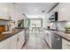 Modern kitchen featuring gray counter tops, tile backsplash, white cabinets, and a bright eating nook at 3722 S Quebec St, Denver, CO 80237