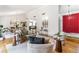 Bright living room with modern furnishings, high ceilings, and bright red entrance door at 3722 S Quebec St, Denver, CO 80237