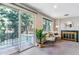 Bright living room with sliding glass doors leading to balcony and a decorative fireplace at 3722 S Quebec St, Denver, CO 80237