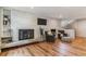 Cozy living room with brick fireplace, hardwood floors and ample natural light at 3722 S Quebec St, Denver, CO 80237