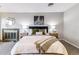 Comfortable main bedroom featuring a decorative fireplace, bedside tables, and accent decor at 3722 S Quebec St, Denver, CO 80237