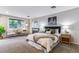 Main bedroom features a window, fireplace, bedside tables, lamps, and a decorative seating area at 3722 S Quebec St, Denver, CO 80237