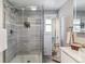 Modern shower with gray tile, rainfall showerhead, and glass enclosure at 3722 S Quebec St, Denver, CO 80237
