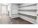 Versatile storage room with built-in shelving and sleek, dark-toned hardwood flooring at 3722 S Quebec St, Denver, CO 80237