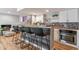 Stylish wet bar with wood countertop, backsplash, modern appliances and bar seating at 3722 S Quebec St, Denver, CO 80237