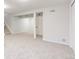 Spacious basement with neutral carpet, white walls, and access to additional storage space at 6285 S Oneida Way, Centennial, CO 80111