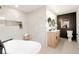 Stylish bathroom featuring double sinks, marble tile, soaking tub and a frameless glass shower at 6285 S Oneida Way, Centennial, CO 80111