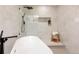 Beautiful bathroom featuring a frameless glass shower and a wooden stool with a white towel at 6285 S Oneida Way, Centennial, CO 80111