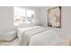 Serene bedroom with large window and neutral decor, featuring white linens and wood floors at 6285 S Oneida Way, Centennial, CO 80111