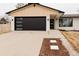 Stylish home with a modern garage door, complementary wood accents and a well-manicured yard at 6285 S Oneida Way, Centennial, CO 80111