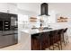 Contemporary kitchen island with bar seating, stainless steel appliances, and stylish decor on shelving at 6285 S Oneida Way, Centennial, CO 80111