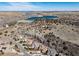 Expansive aerial view of upscale homes nestled in a scenic landscape with rolling hills and a tranquil lake at 8310 Raphael Ln, Littleton, CO 80125
