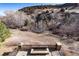 An outdoor fire pit on the back patio with a scenic view of trees, offering a serene space for relaxation and nature at 8310 Raphael Ln, Littleton, CO 80125