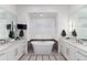 Spa-like bathroom with a freestanding tub, dual vanities, and contemporary fixtures at 8310 Raphael Ln, Littleton, CO 80125