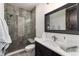 Bathroom featuring a glass-enclosed shower with stylish tiles, and a sleek vanity offering a blend of comfort and design at 8310 Raphael Ln, Littleton, CO 80125