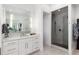Bright bathroom showcasing a glass-enclosed shower and spacious vanity with modern lighting at 8310 Raphael Ln, Littleton, CO 80125