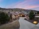 Stunning Tuscan-style home featuring a tile roof and grand driveway nestled against a scenic mountain backdrop at 8310 Raphael Ln, Littleton, CO 80125